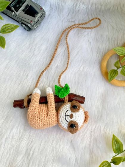 This adorable sloth car hanging was so much fun to make. He hangs lazily from a real wooden branch, adding a touch of cuteness to your car's rearview mirror.