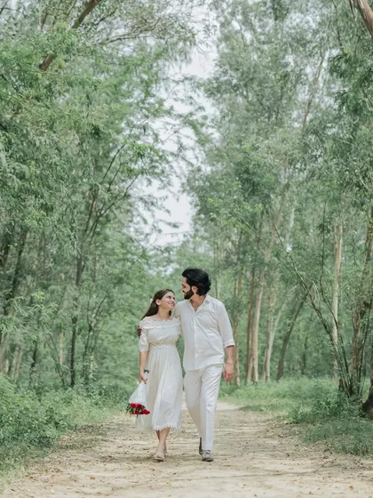 A quiet walk through a wooded path. We capture the simple, intimate moments of togetherness that make your love story unique.