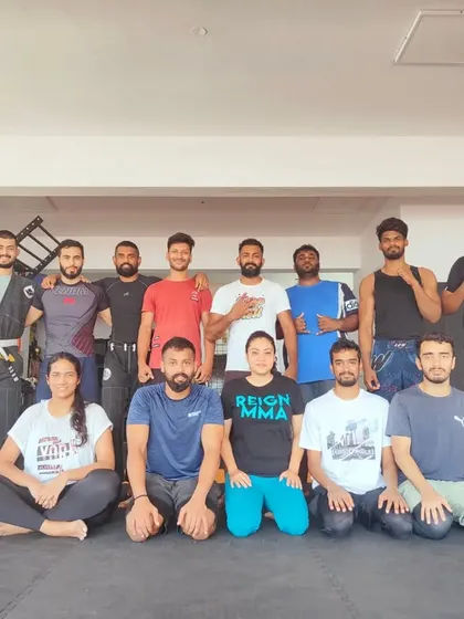 A group photo celebrating four years of Reign MMA. We have built a strong, dedicated community that I am proud to lead.
