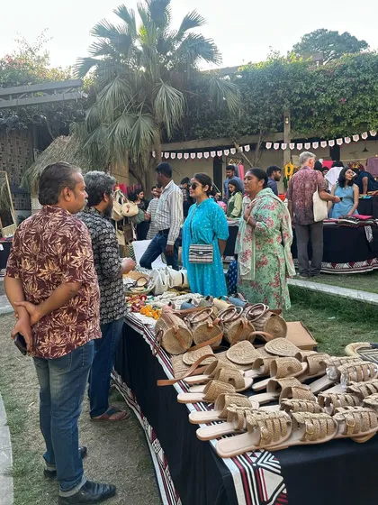 A wide array of handcrafted accessories, including woven baskets and leather footwear, on display at the Urmul Mela.