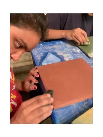 A participant learns to polish a Tadelakt tile, one of the hands-on activities offered at our biennale booth.