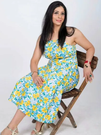 A seated pose from the same fashion shoot, showing the versatility of the natural glam look. It's effortlessly stunning.