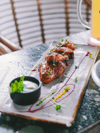 Tender, saucy chicken wings served with a cooling dip. They are a little bit spicy, a little bit sweet, and completely addictive.