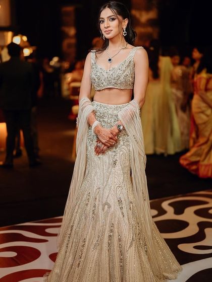 The full look for this glamorous cocktail night. The makeup is soft yet defined, letting her modern couture lehenga and her natural beauty take center stage.