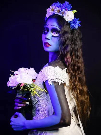A profile view showing the detailed body painting on the arm and the delicate floral crown, capturing the iconic look of the character.
