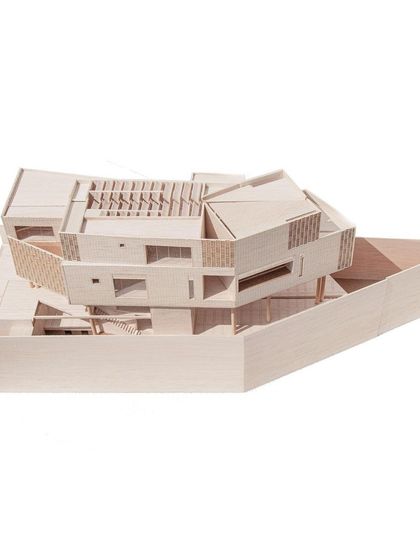 An angled view of the sectional model for Office A, showing the intricate play of volumes, courtyards, and staircases that define the project.