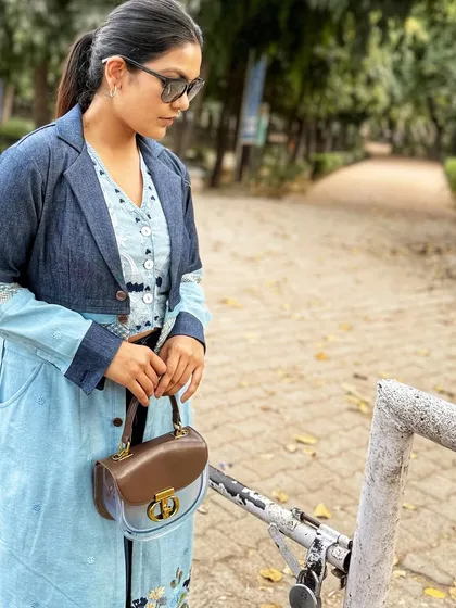 This angle gives a better view of the purse's details, including the polished gold-tone clasp that adds a touch of luxury.