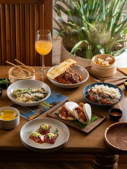An elegant Asian meal for one, styled with natural light by a window. This creates a calm and sophisticated dining atmosphere.