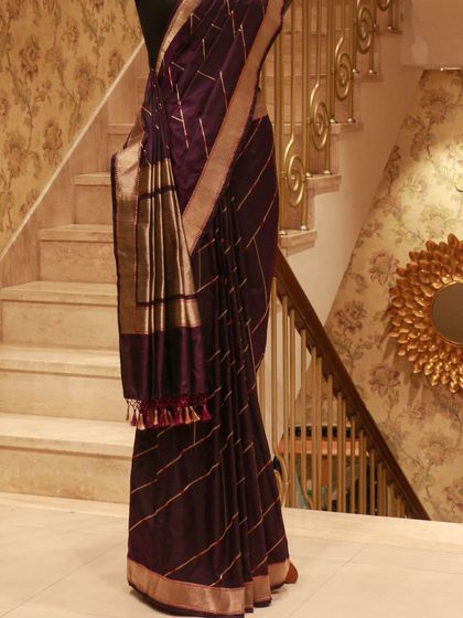 A luxurious Banarasi Kathan silk saree in deep purple with a soft drape, perfect for evening celebrations.