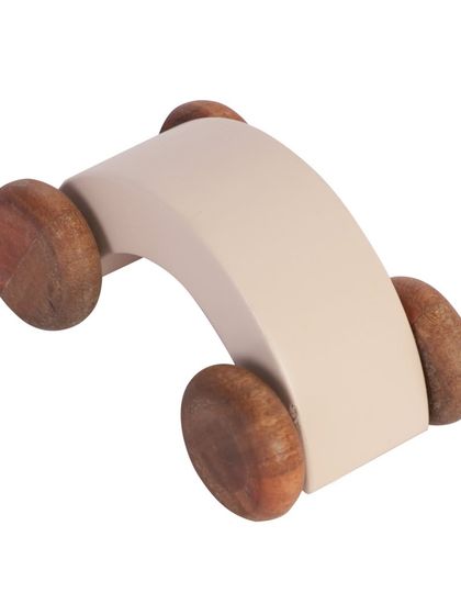 An angled shot of a simple, modern wooden toy car.