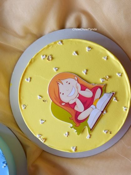 A simple and cute character cake with a yellow buttercream finish, perfect for a small celebration.