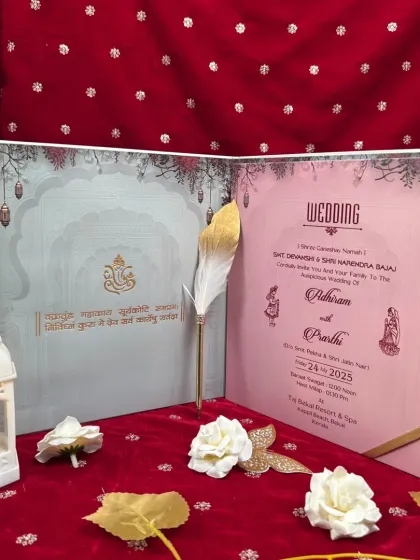 An open view of a gate-fold invitation, showing the main wedding insert alongside a panel with a Ganesha mantra for blessings.