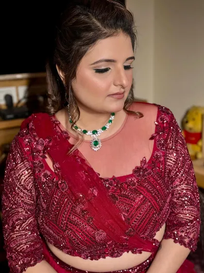 Ready for the cocktail night in a stunning wine-red outfit. The makeup is glamorous, with a defined eye and glowing skin to match the celebratory vibe.