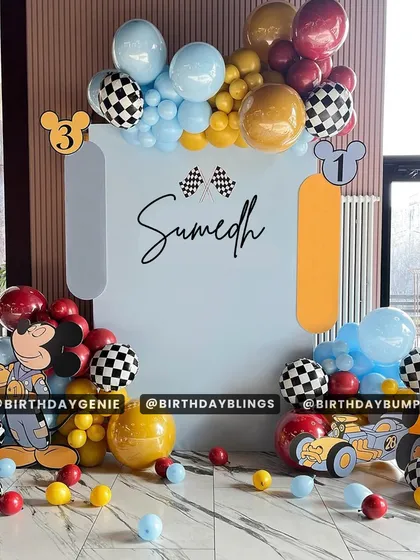 A Mickey Mouse race car theme, combining two popular ideas into one exciting party. The checkered-flag balloons and race-themed Mickey cutout are key details.