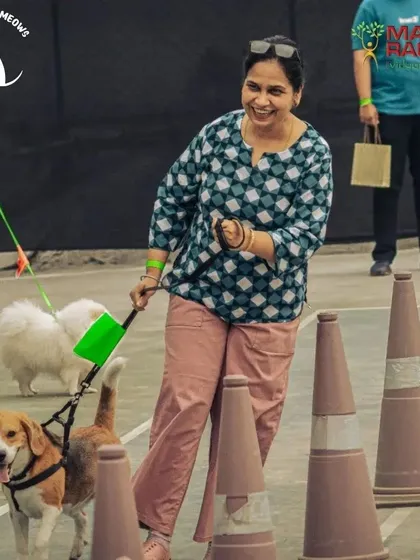 The lemon and spoon race is always a crowd favorite. I plan a variety of games that are fun for both pets and their parents, ensuring everyone is engaged and smiling. This shot shows a pet parent and her beagle navigating the course at our Pawsome Olympics.
