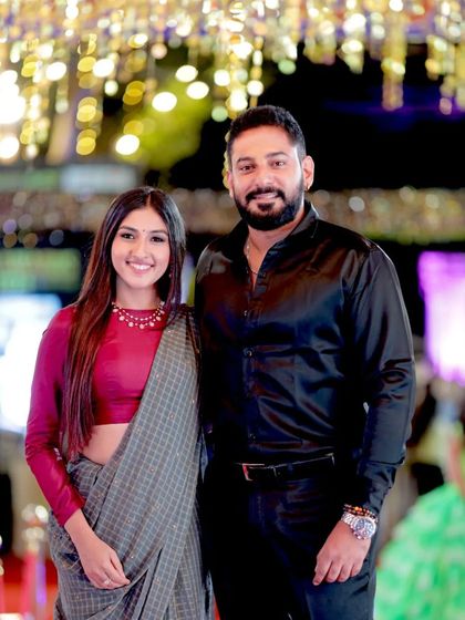 A classic couple portrait of Prajwal and Ragini Devaraj, looking stylish and happy.