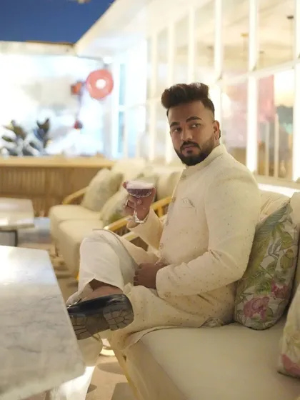 For a festive celebration, this client chose a classic ivory embroidered achkan-style kurta, looking relaxed and stylish.
