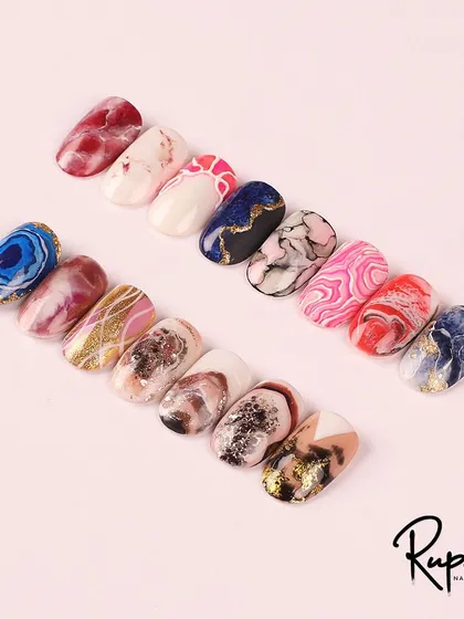 This image is from my marble nail art course module. It shows a wide variety of effects, from soft rose quartz to dramatic blue agate and gold-veined stone.