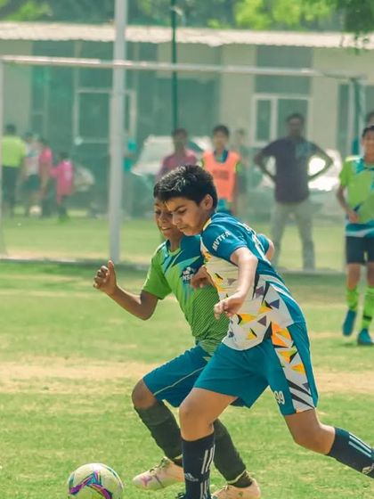 Two players race towards the ball, demonstrating speed and anticipation.