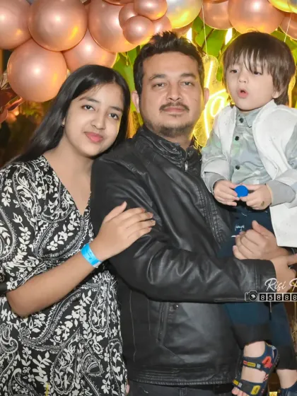 A father with his two children, a teenage daughter and a young son. This portrait captures a relaxed moment with the family at an evening event.