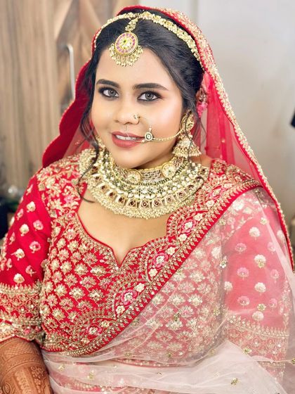 A close-up of this beautiful bride in her traditional red lehenga. The makeup features classic bold eyes and a radiant skin finish.