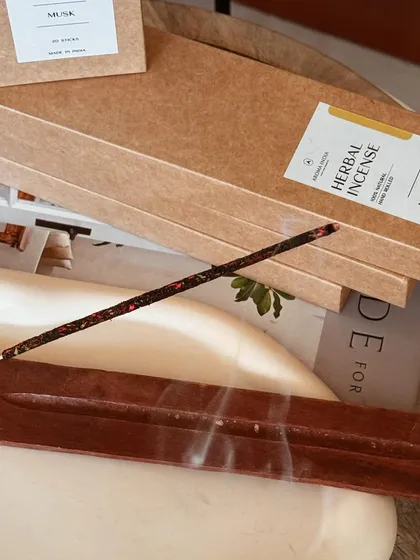 A close-up of our herbal incense burning, releasing its sacred and powerful aroma. Incense is beneficial for cleansing energy, attracting harmony, and deepening yoga and meditation practices.