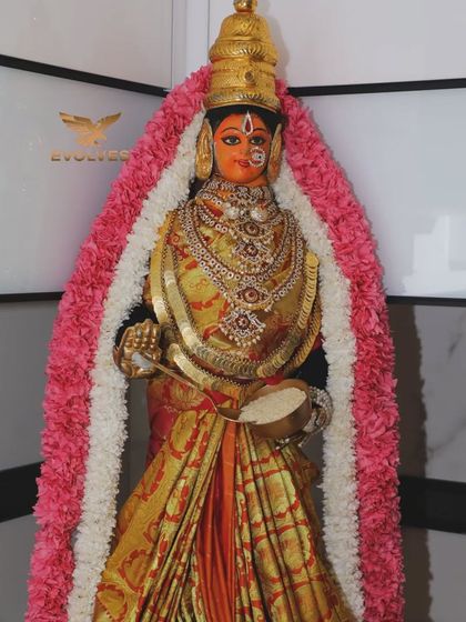 An idol decorated with a beautiful garland for a house warming pooja, showcasing our attention to the sacred details of the ceremony.
