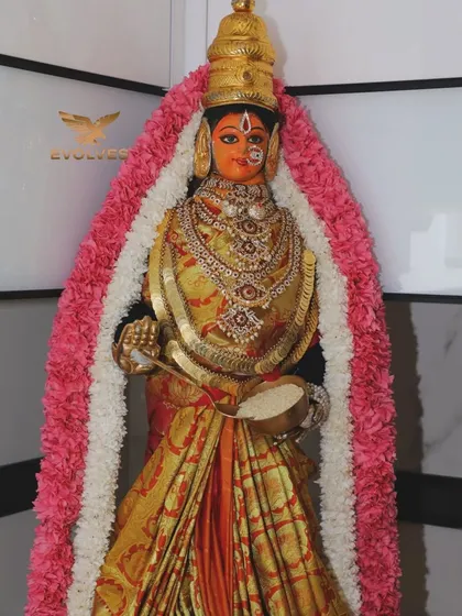 An idol decorated with a beautiful garland for a house warming pooja, showcasing our attention to the sacred details of the ceremony.