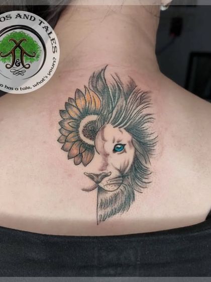 A creative fusion of a lion's face and a sunflower. This design combines the strength of the lion with the beauty of the flower, with a pop of color in the lion's eye.