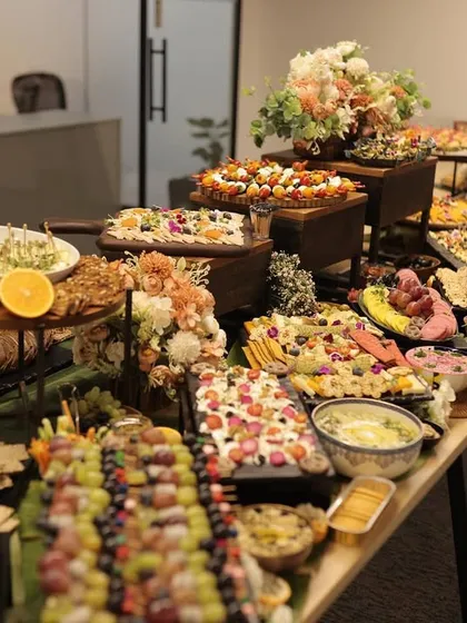 A long shot of a magnificent grazing table I designed for a corporate event. It's filled with a diverse spread of savory and sweet options, ensuring there is something delightful for every guest to enjoy.