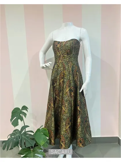 The full view of the strapless paisley brocade dress on a mannequin, highlighting its elegant structure.