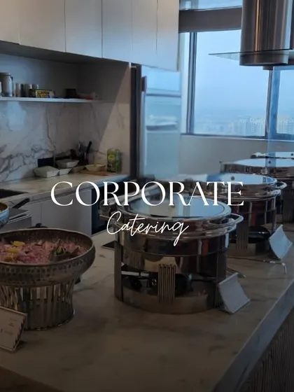 Corporate catering in a modern office space with a stunning view. Our buffet setup with chafing dishes ensures that the food remains hot and fresh for all attendees.