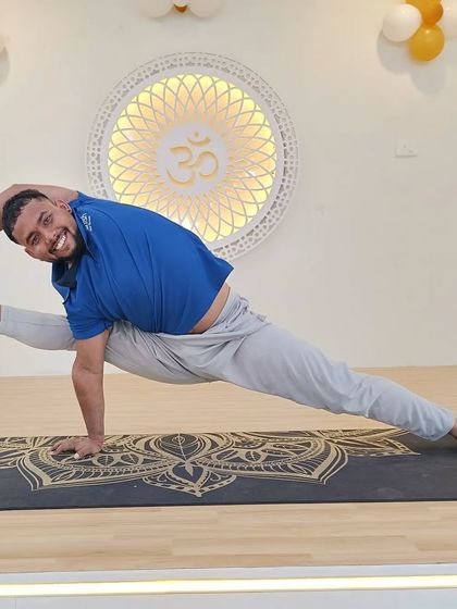 A smiling student in Visvamitrasana, enjoying the challenge and strength of this advanced pose.