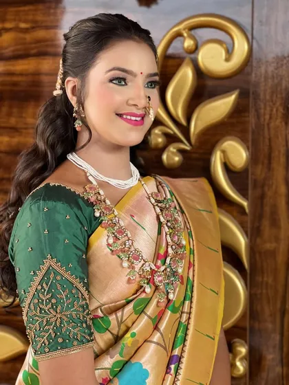 A smiling bride in her yellow `Paithani`, her joy evident. The makeup is kept fresh and radiant to match the celebratory mood.
