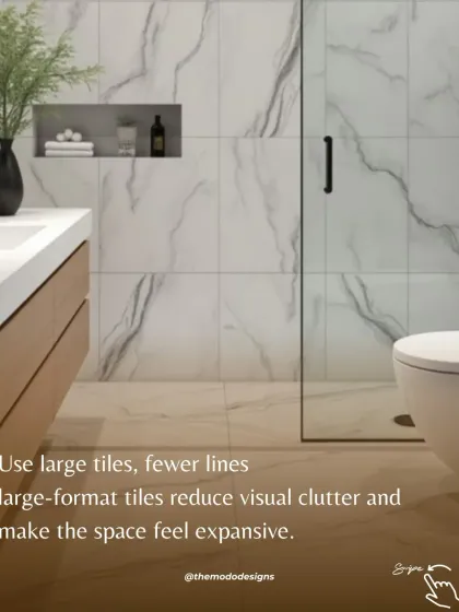 Use large tiles with fewer lines. Large-format tiles, like these marble-effect ones, reduce visual clutter and make a small bathroom feel much more expansive.