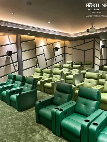 This side-angle view highlights the tiered arrangement of our seating, guaranteeing a clear line of sight for all guests. The combination of dark and light green recliners adds to the sophisticated and modern ambiance of the room.