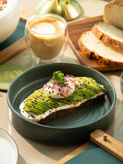 A simple but elegant avocado toast with a poached egg. The clean composition and bright lighting make it look fresh and appealing.