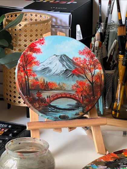 A close up of the round Mt. Fuji painting on its easel.
