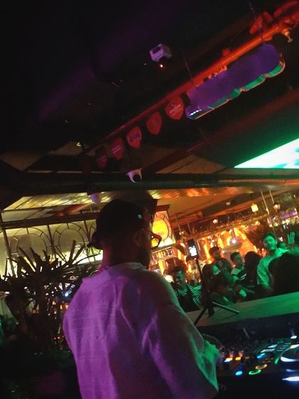 A view from behind the decks at Social, with the crowd visible in the background.
