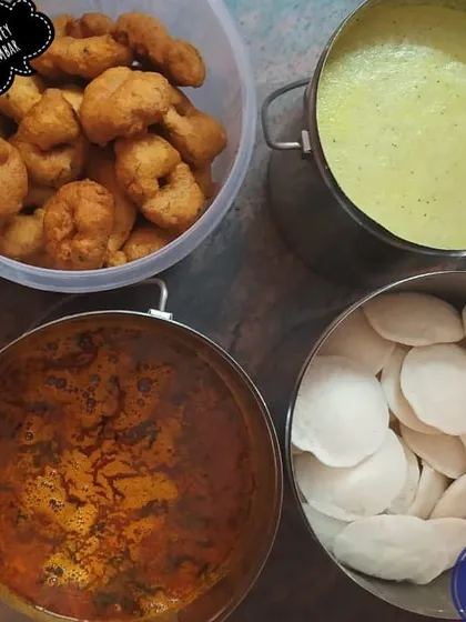 A classic South Indian breakfast spread prepared for bulk delivery. This order included dozens of soft mini idlis, crispy medu vadas, aromatic sambar, and coconut chutney, all packed in steel containers to keep them hot and fresh.