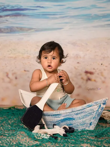 Explore our full nautical and beach-themed collection. These images showcase the variety of poses and angles possible with our boat prop, sand-colored flooring, and ocean backdrop.