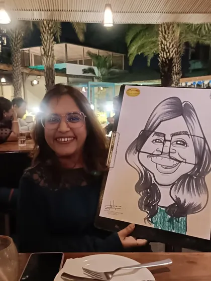 A guest at Mountain High restaurant in Wanowrie, happy with her caricature. You can find me here on weekends, sketching diners.