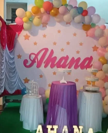A simple and sweet pastel balloon arch against a custom circular backdrop.