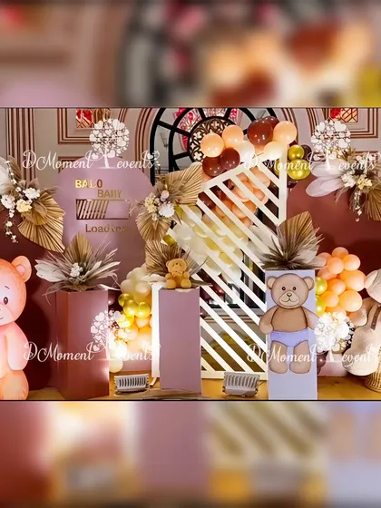 The main stage for the teddy bear Mundan ceremony. The decor features a sophisticated palette of brown and pastel pink, with modern arched backdrops, dried florals, and adorable teddy bear props.