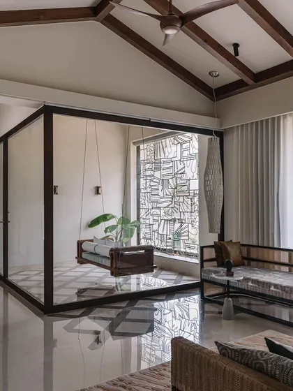 For this home in Coimbatore, we designed a large, autonomous metal grill installation. It serves as a window grill that provides security while also functioning as a standalone piece of abstract art, interacting with the light and reflections from the polished floor.