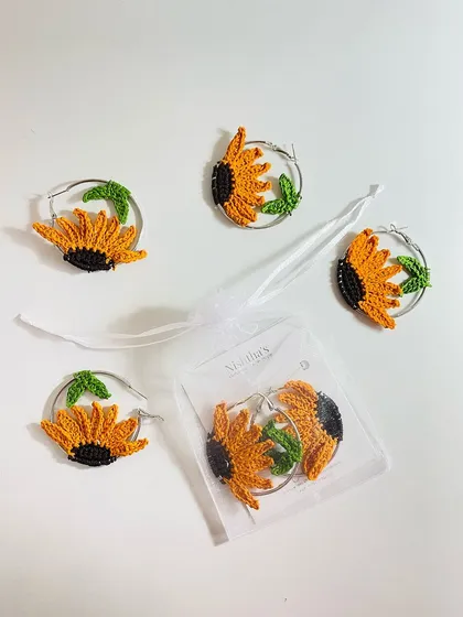 These sunflower hoop earrings are a perfect example of intricate crochet work. I use a very thin cotton thread and a tiny hook to create each petal and leaf with precision. They are lightweight, unique, and make a beautiful gift.