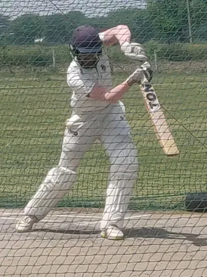 A batsman playing a front-foot defensive shot, showing good balance and head position. Strong basics are non-negotiable.