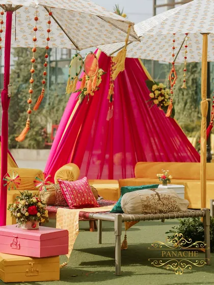 A cozy and traditional manji lounge setup, perfect for a relaxed Haldi function. We used colorful cushions, phulkari runners, and decorative umbrellas to create this inviting space.