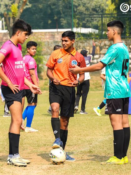 A referee talks to the team captains before kick-off, setting the tone for a fair match.