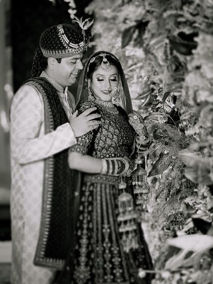 A timeless black and white portrait of the couple on their wedding day. This style emphasizes the emotion and connection between them, creating a classic piece of art.